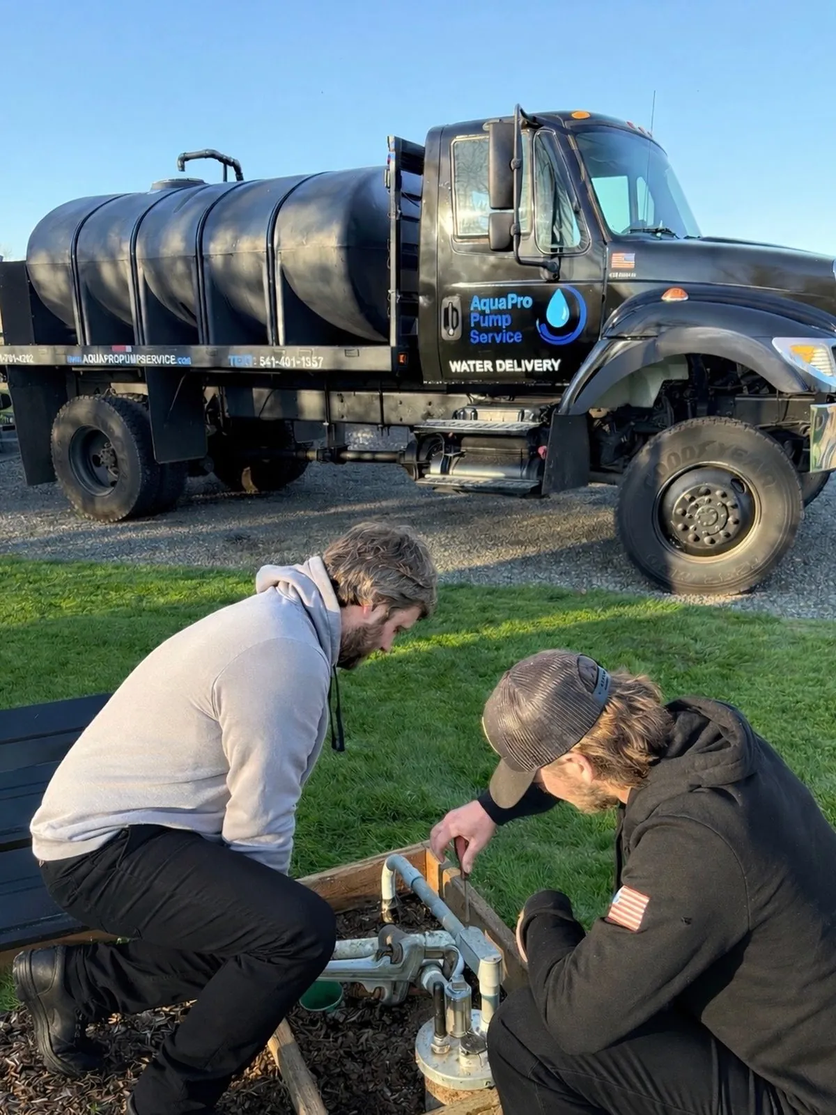 Aqua Pro Pump Service technicians repairing a well pump on-site in Albany, Oregon
