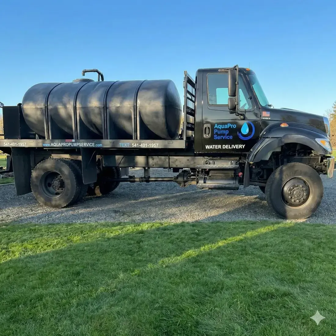 Bulk water delivery truck filling a residential storage tank